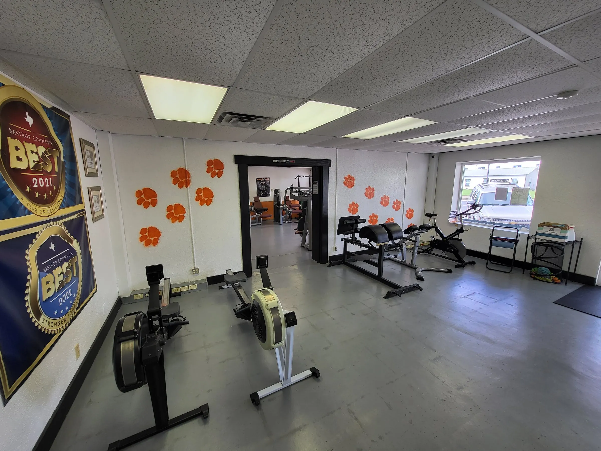 Rowing machines beneath Best of Bastrop County award banners